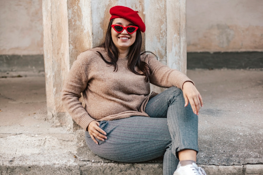 Aspiring plus-size model posing confidently in front of a camera