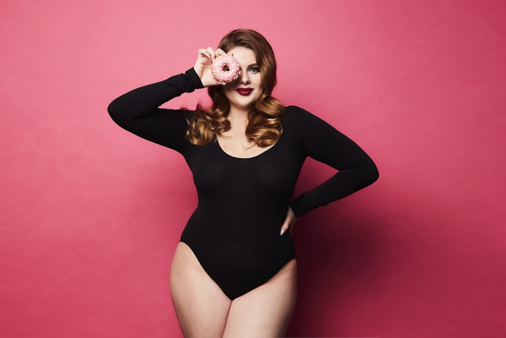 Aspiring plus-size model posing confidently in front of a camera