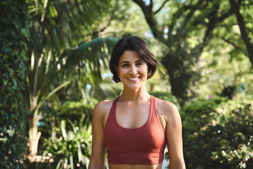 A confident fitness model posing in activewear during a professional photoshoot.