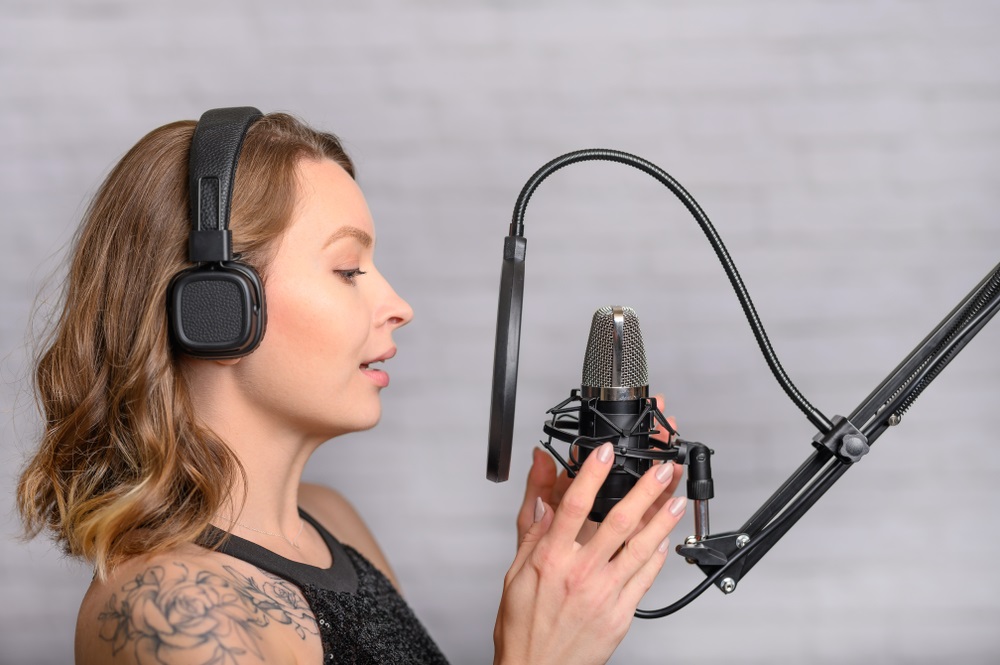 A voice actor recording in a professional home studio, showcasing their talent for voice over agencies.