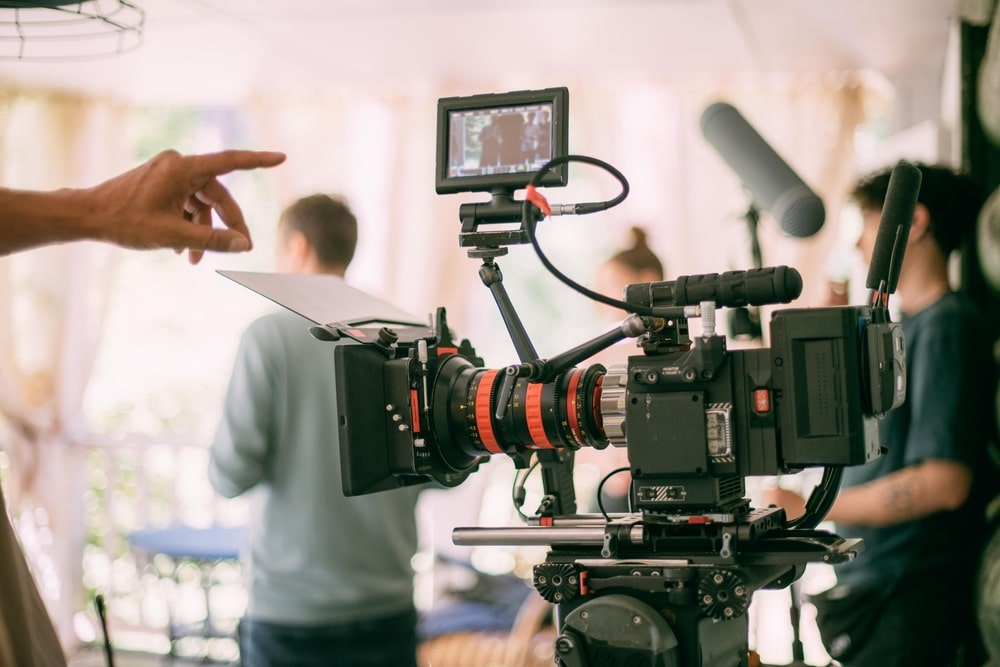 Aspiring filmmaker working with a camera crew on a movie set.