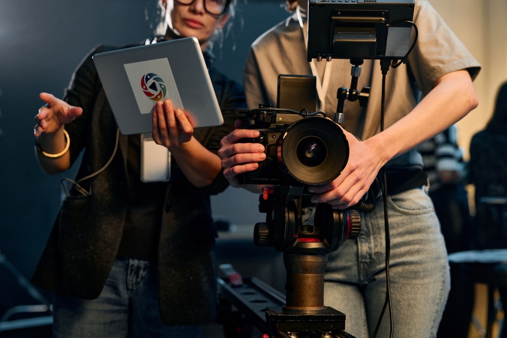 Aspiring filmmaker working with a camera crew on a movie set.