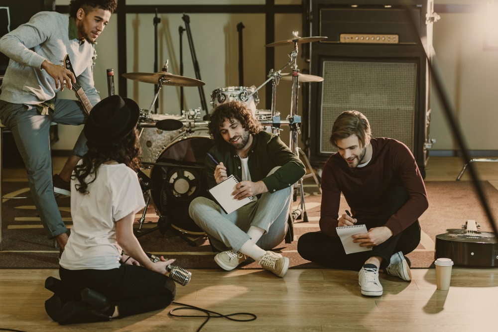 Musicians collaborating in a music group during a rehearsal.