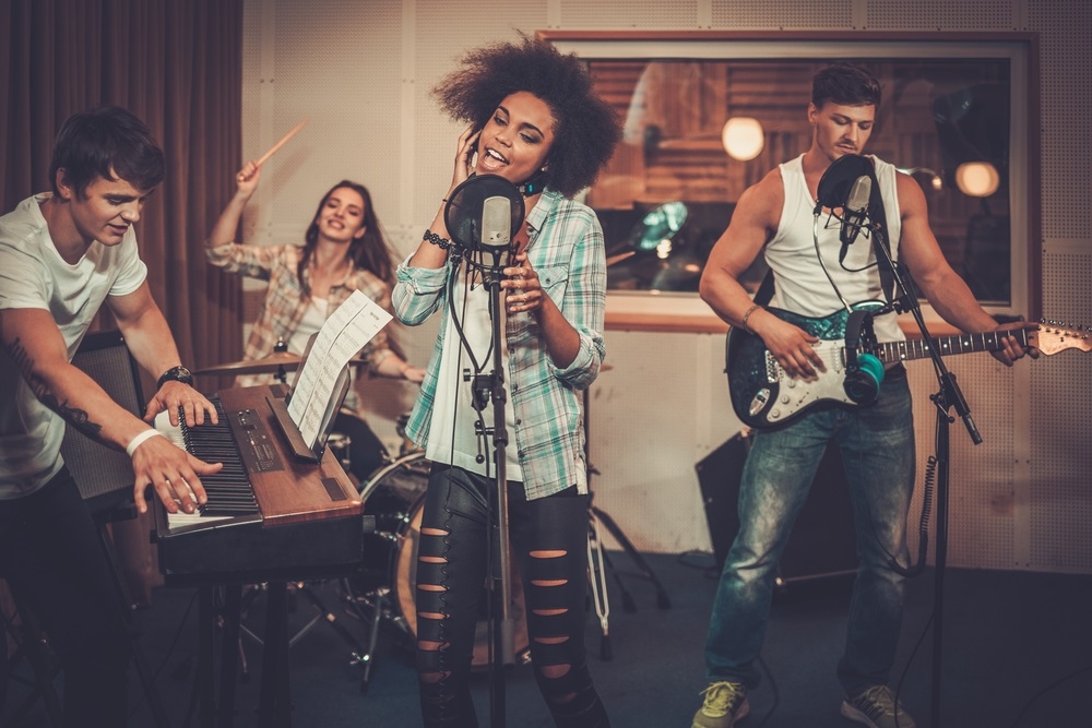 Musicians collaborating in a music group during a rehearsal.