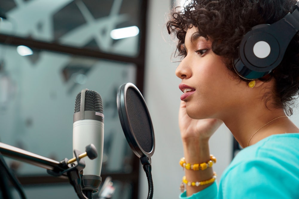 A vocalist recording in a professional studio for a commercial.