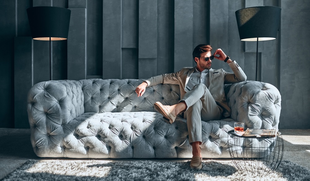 A male model posing confidently at a professional photoshoot.