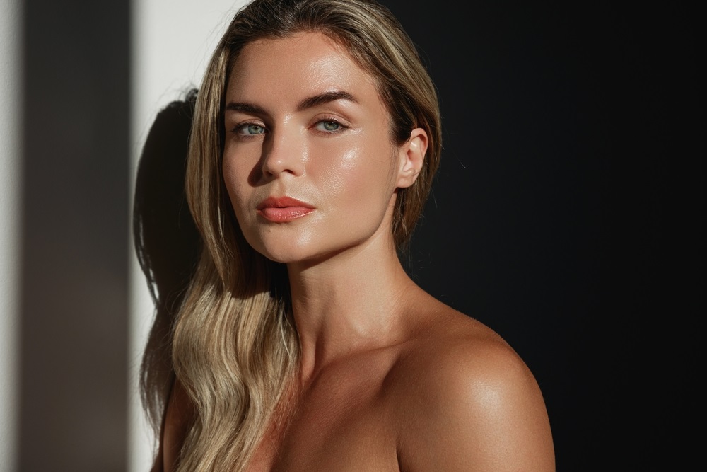 Aspiring model preparing for a modeling job audition in a professional studio.