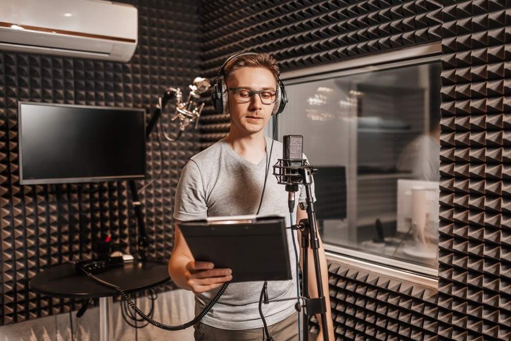 Commercial voice actor recording a script in a home studio
