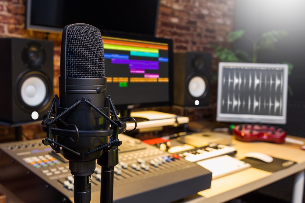 Commercial voice actor recording a script in a home studio