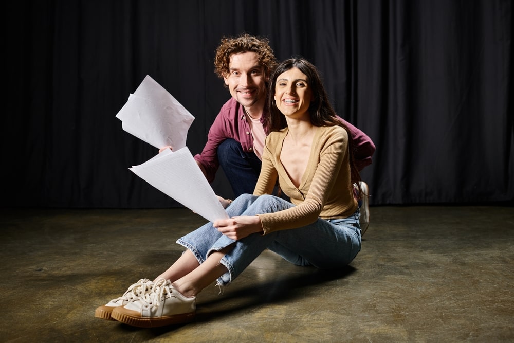 An aspiring actor holding a script on a film set, considering if a film degree is needed for an acting job.