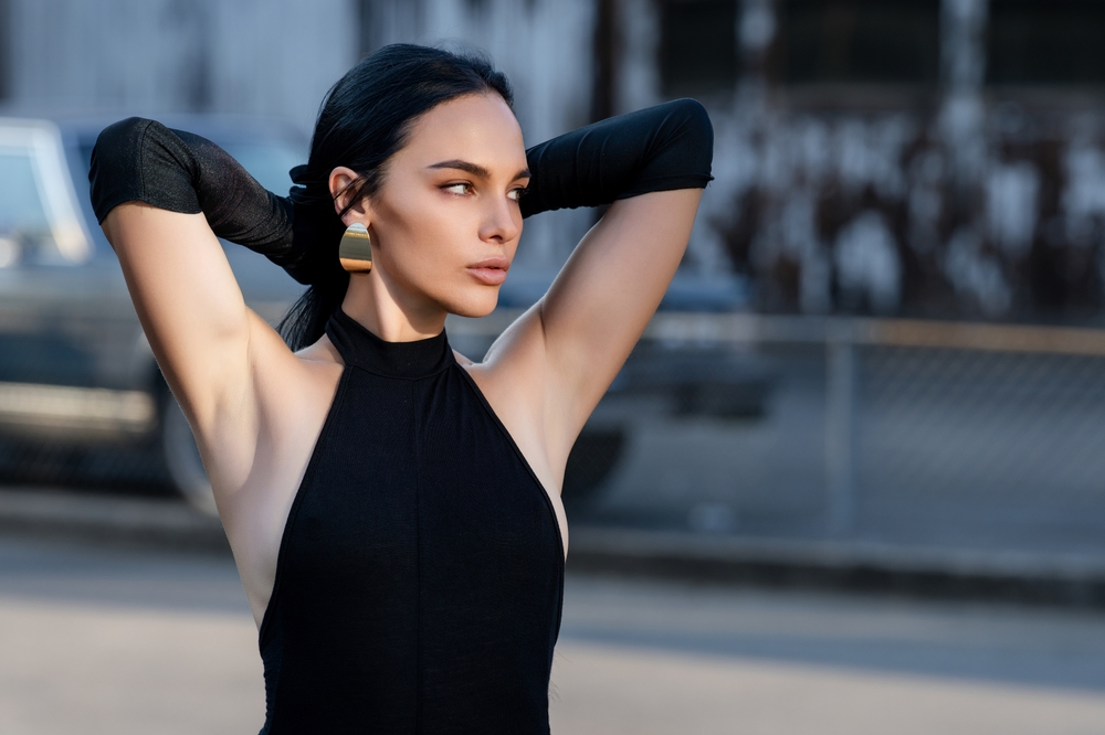 A diverse group of models posing in elegant, modest attire at a professional photo shoot.